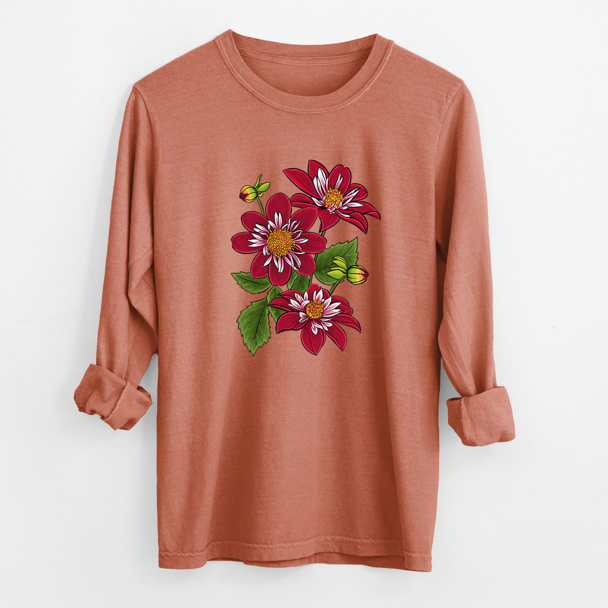 Yam burnt orange Comfort Colors long sleeve shirt laid flat with the cuffs rolled, printed with a full-color illustration of deep red dahlia flowers with green leaves and a small bee.
