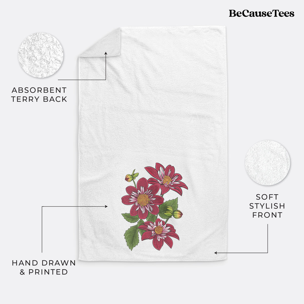 White hand towel printed with a full-color illustration of deep red dahlia flowers with green leaves and a small bee.