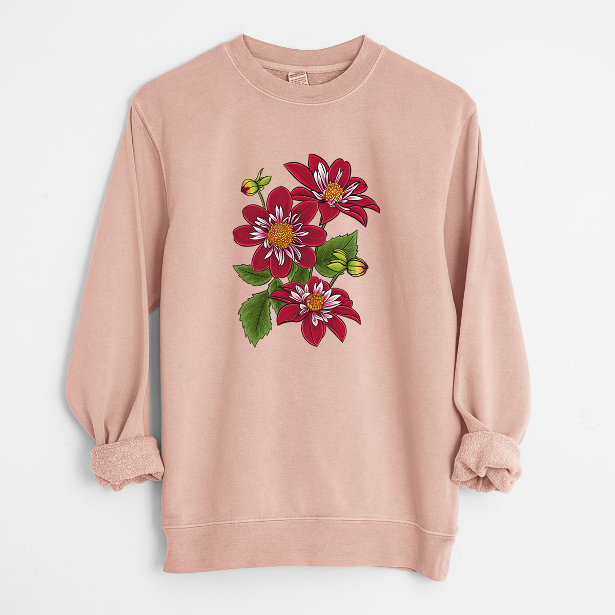 Dusty pink pigment dyed crewneck sweatshirt laid flat with the sleeves rolled, printed with a full-color illustration of deep red dahlia flowers with green leaves and a small bee.