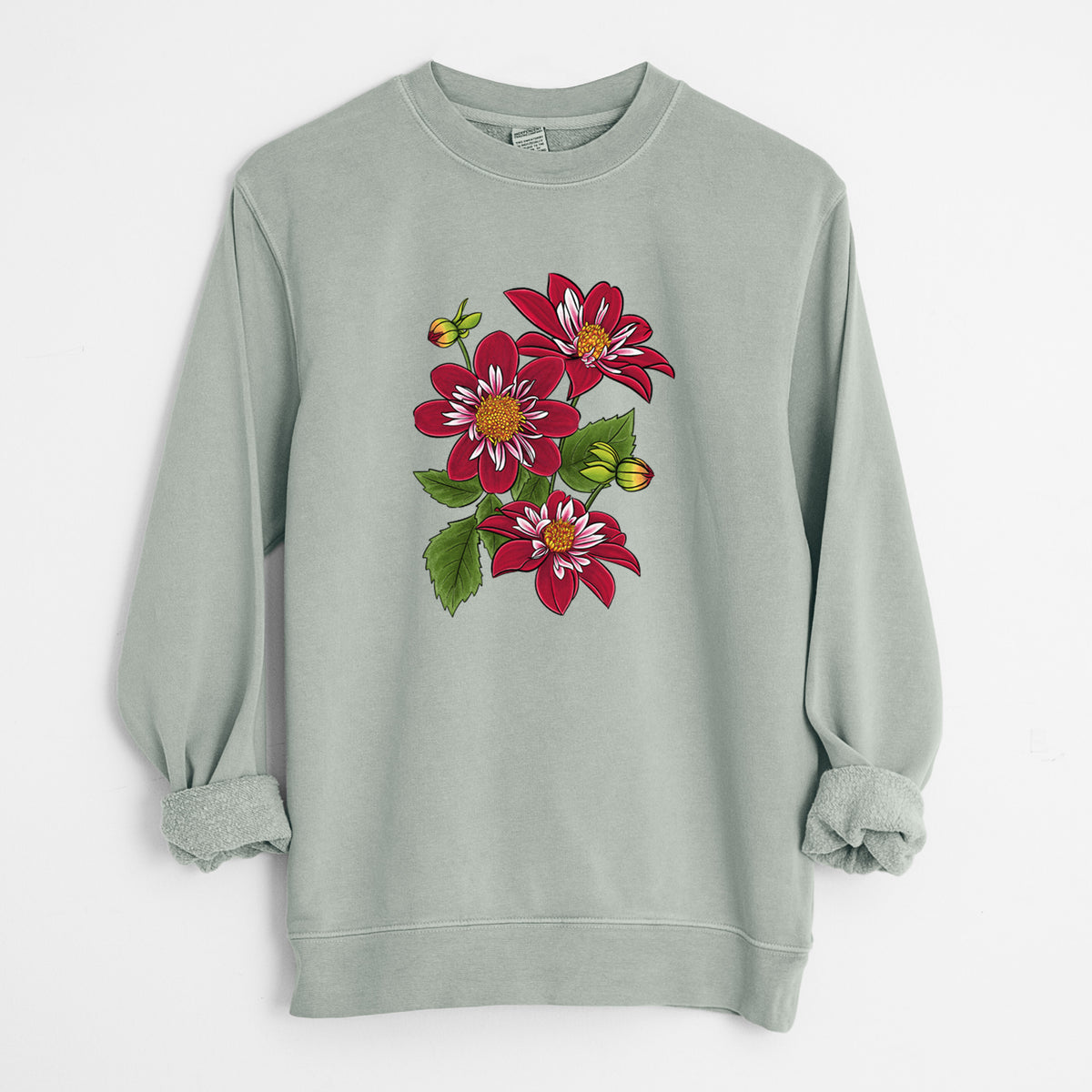 Sage green pigment dyed crewneck sweatshirt laid flat with the sleeves rolled, printed with a full-color illustration of deep red dahlia flowers with green leaves and a small bee.