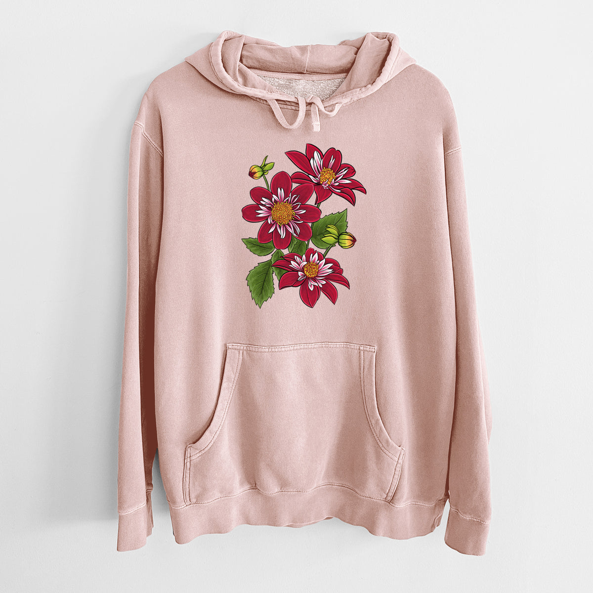 Dusty pink pigment dyed hoodie laid flat, printed with a full-color illustration of deep red dahlia flowers with green leaves and a small bee.