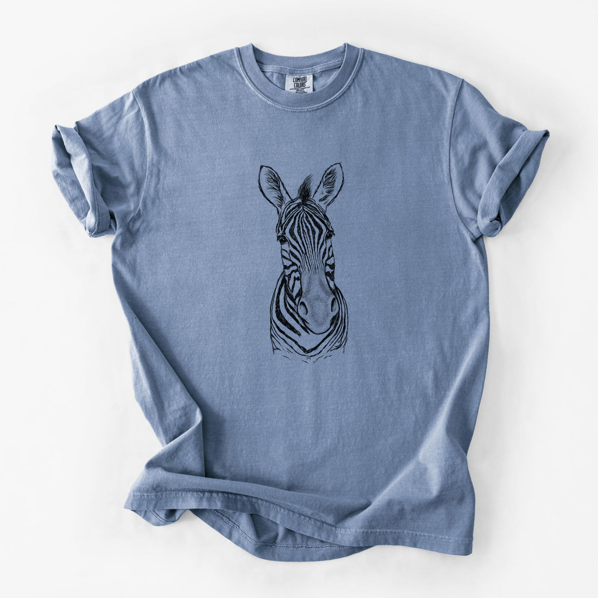 Blue jean Comfort Colors t-shirt laid flat, printed with a detailed black ink portrait of a Damara zebra facing forward.