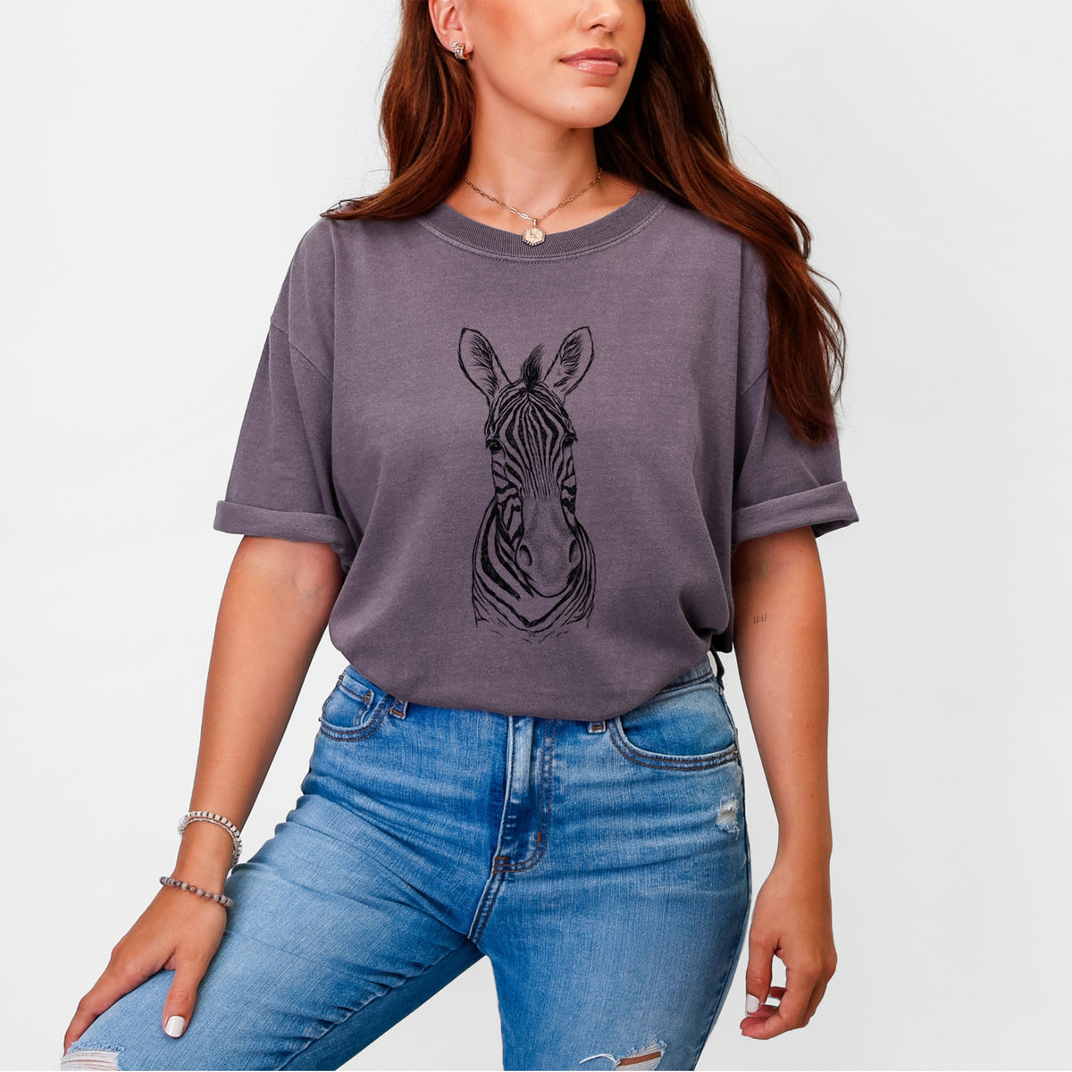 Woman wearing a Comfort Colors t-shirt printed with a detailed black ink portrait of a Damara zebra facing forward.