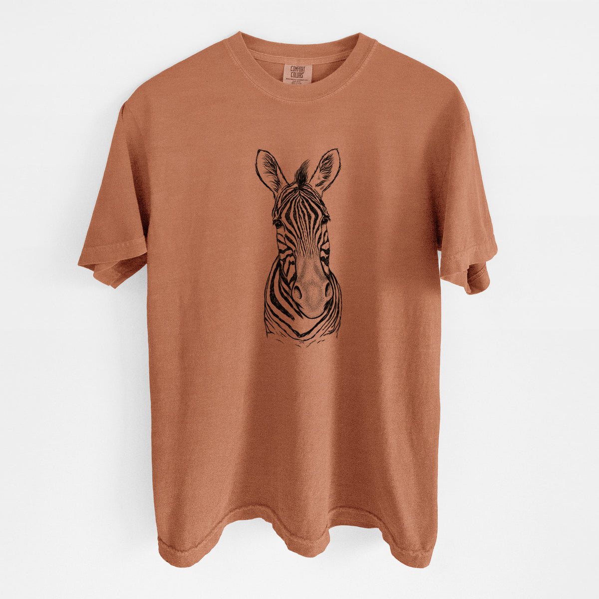 Yam burnt orange Comfort Colors t-shirt laid flat, printed with a detailed black ink portrait of a Damara zebra facing forward.