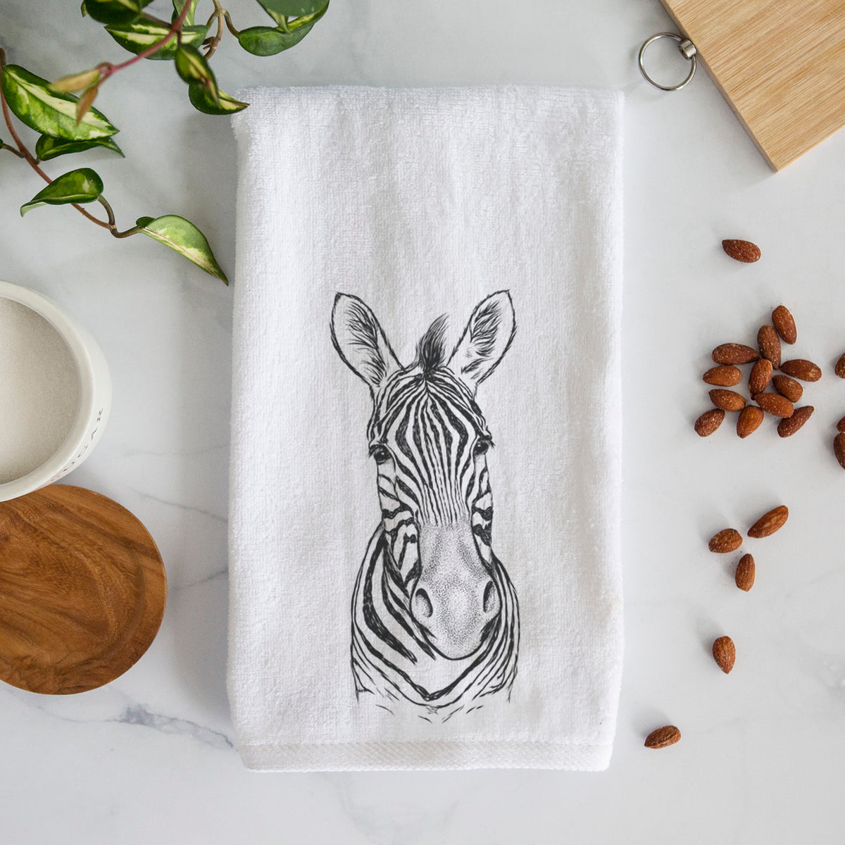White hand towel printed with a detailed black ink portrait of a Damara zebra facing forward.