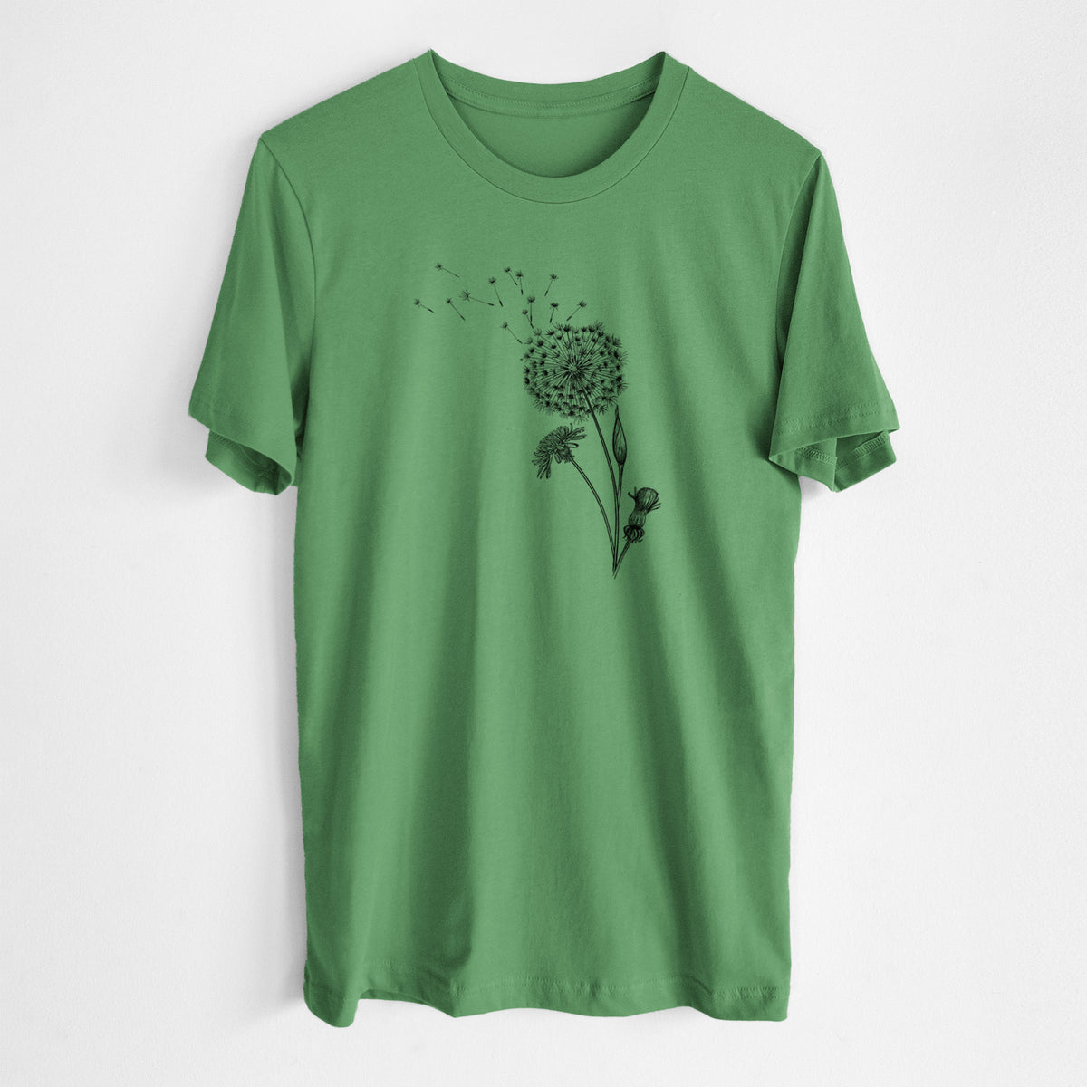 Leaf green lightweight cotton t-shirt laid flat, printed with a black ink line drawing of a dandelion seed head with seeds blowing away.