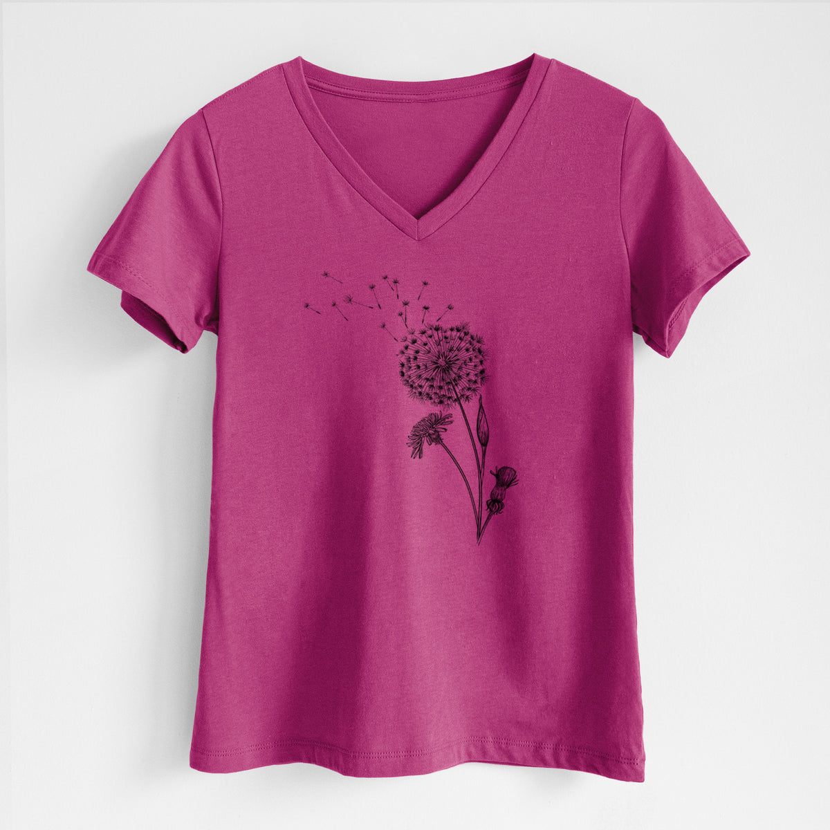 Berry pink women's relaxed fit cotton V-neck t-shirt laid flat, printed with a black ink line drawing of a dandelion seed head with seeds blowing away.