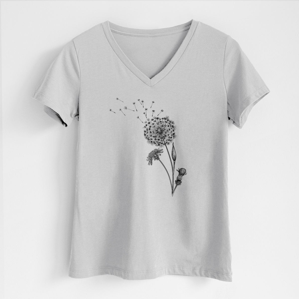 Lunar grey women's relaxed fit cotton V-neck t-shirt laid flat, printed with a black ink line drawing of a dandelion seed head with seeds blowing away.