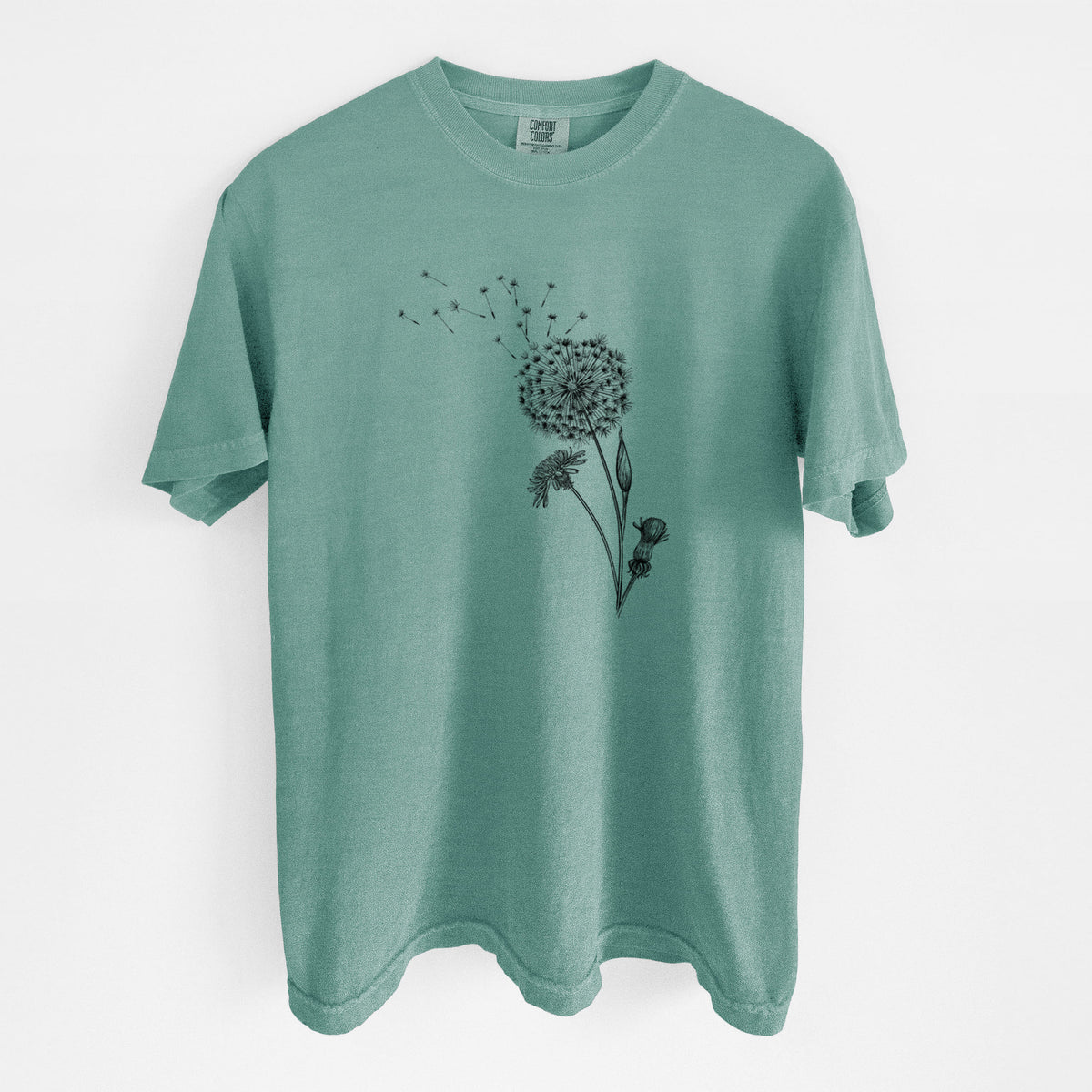 Reef green Comfort Colors t-shirt laid flat, printed with a black ink line drawing of a dandelion seed head with seeds blowing away.