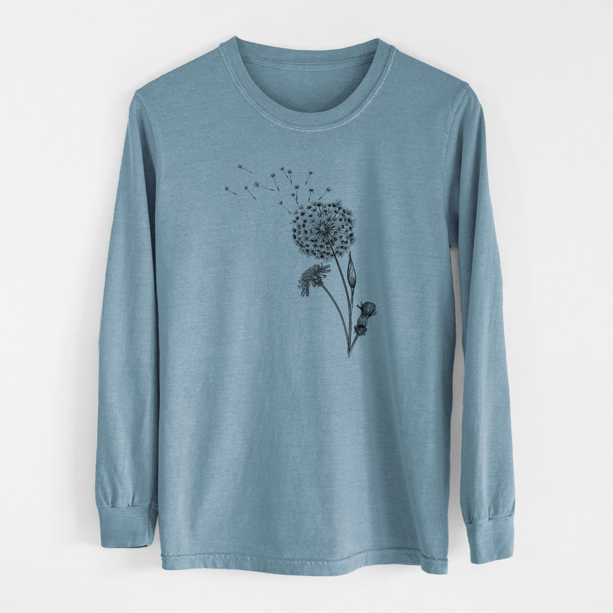 Steel blue Comfort Colors long sleeve shirt laid flat, printed with a black ink line drawing of a dandelion seed head with seeds blowing away.