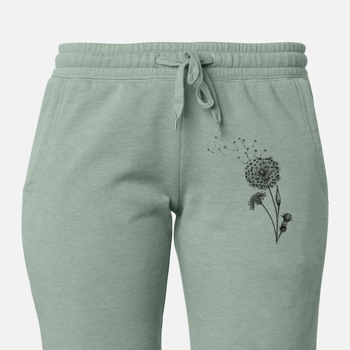 Front of sage green Cali Wave sweatpants, printed with a black ink line drawing of a dandelion seed head with seeds blowing away on the leg.