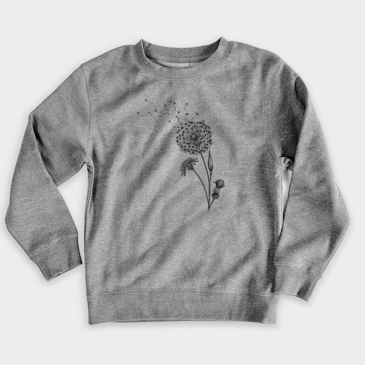 Nickel grey youth crewneck sweatshirt laid flat, printed with a black ink line drawing of a dandelion seed head with seeds blowing away.