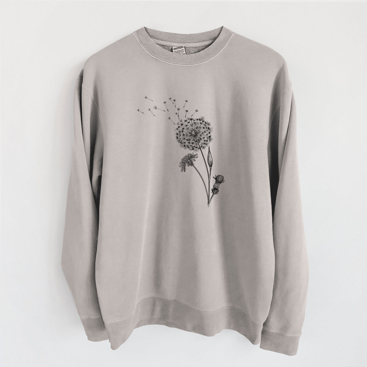 Cement grey pigment dyed crewneck sweatshirt laid flat, printed with a black ink line drawing of a dandelion seed head with seeds blowing away.