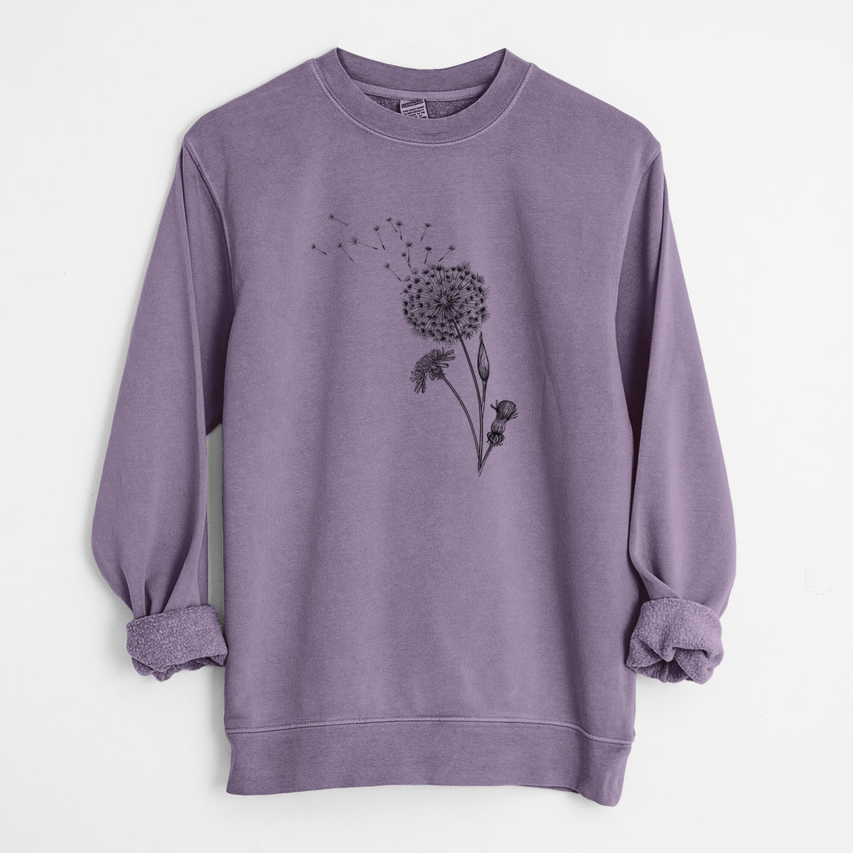 Plum purple pigment dyed crewneck sweatshirt laid flat with the sleeves rolled, printed with a black ink line drawing of a dandelion seed head with seeds blowing away.