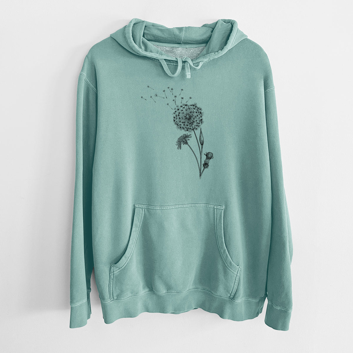 Mint green pigment dyed hoodie laid flat, printed with a black ink line drawing of a dandelion seed head with seeds blowing away.