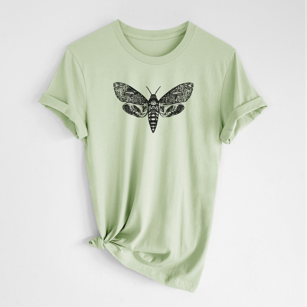 Spring green lightweight cotton t-shirt laid flat with the sleeves rolled, printed with a detailed black ink illustration of a death's-head hawkmoth with its wings spread.