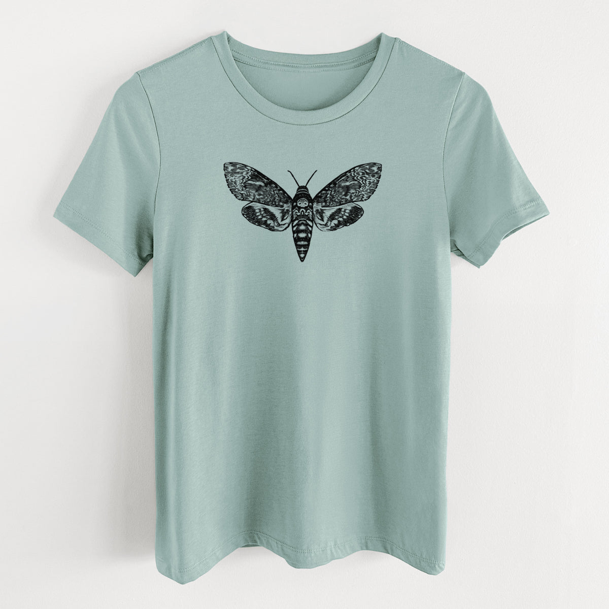 Dusty blue women's relaxed fit cotton t-shirt laid flat, printed with a detailed black ink illustration of a death's-head hawkmoth with its wings spread.