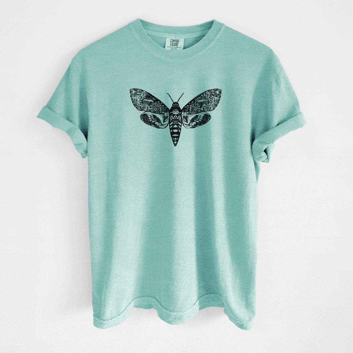 Chalky mint Comfort Colors t-shirt laid flat, printed with a detailed black ink illustration of a death's-head hawkmoth with its wings spread.