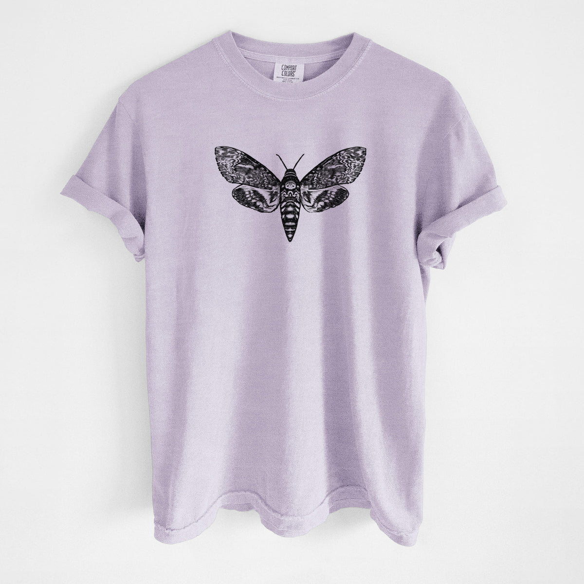 Orchid purple Comfort Colors t-shirt laid flat, printed with a detailed black ink illustration of a death's-head hawkmoth with its wings spread.