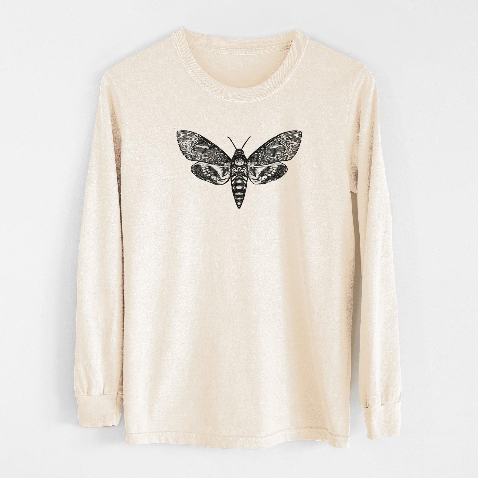 Ivory Comfort Colors long sleeve shirt laid flat, printed with a detailed black ink illustration of a death's-head hawkmoth with its wings spread.