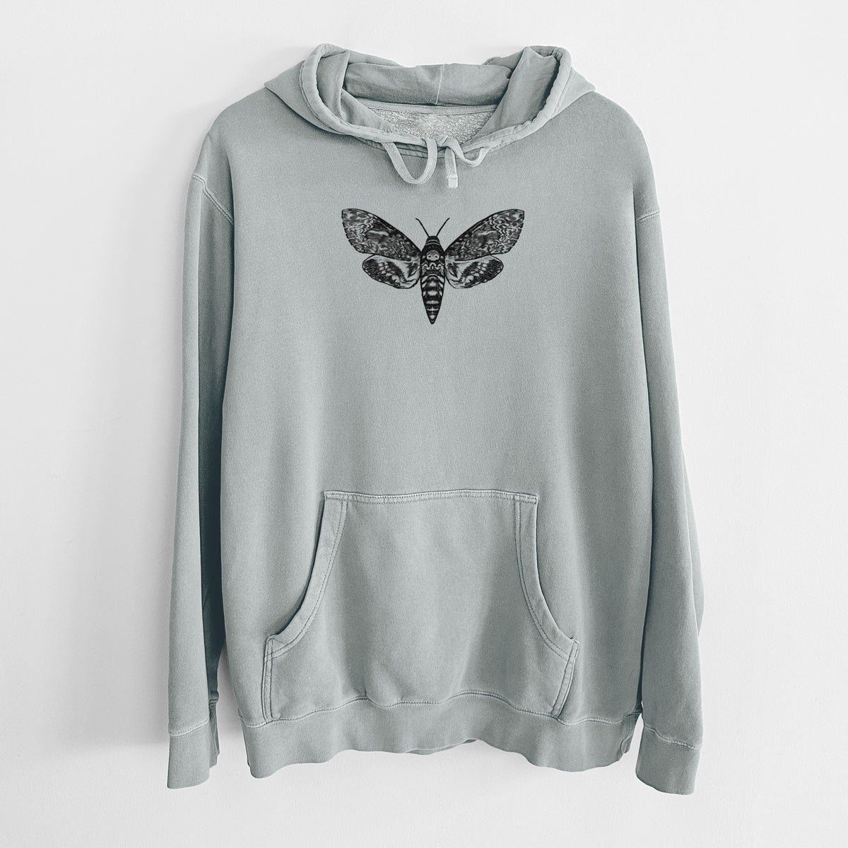 Sage green pigment dyed hoodie laid flat, printed with a detailed black ink illustration of a death's-head hawkmoth with its wings spread.