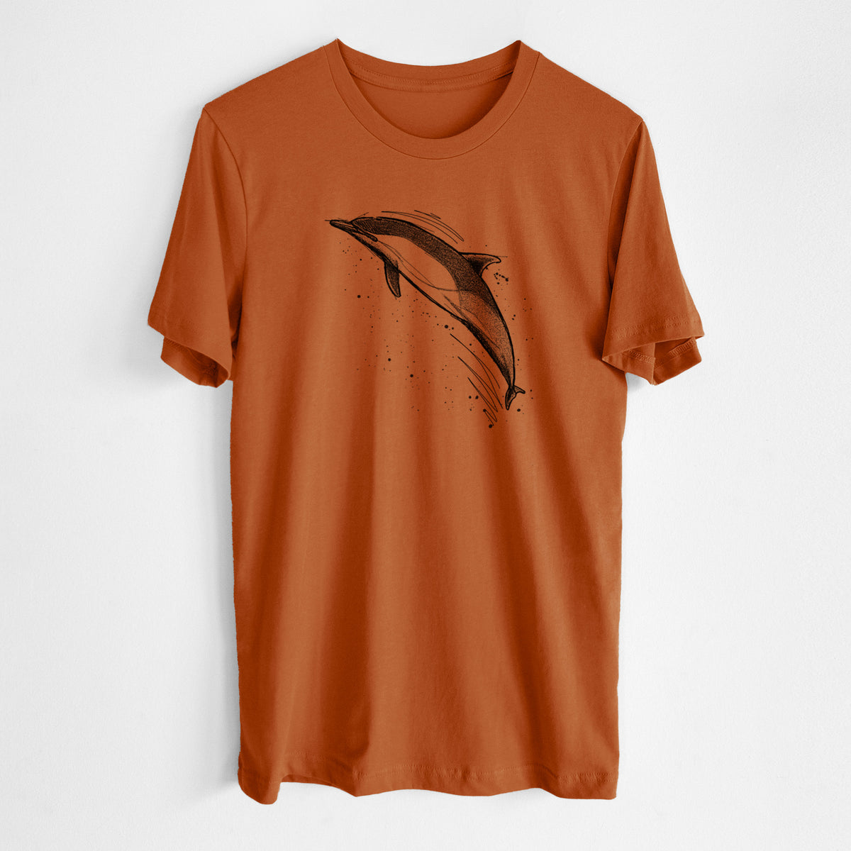 Autumn lightweight cotton t-shirt laid flat, printed with a black ink illustration of a common dolphin leaping, with ink splatters.