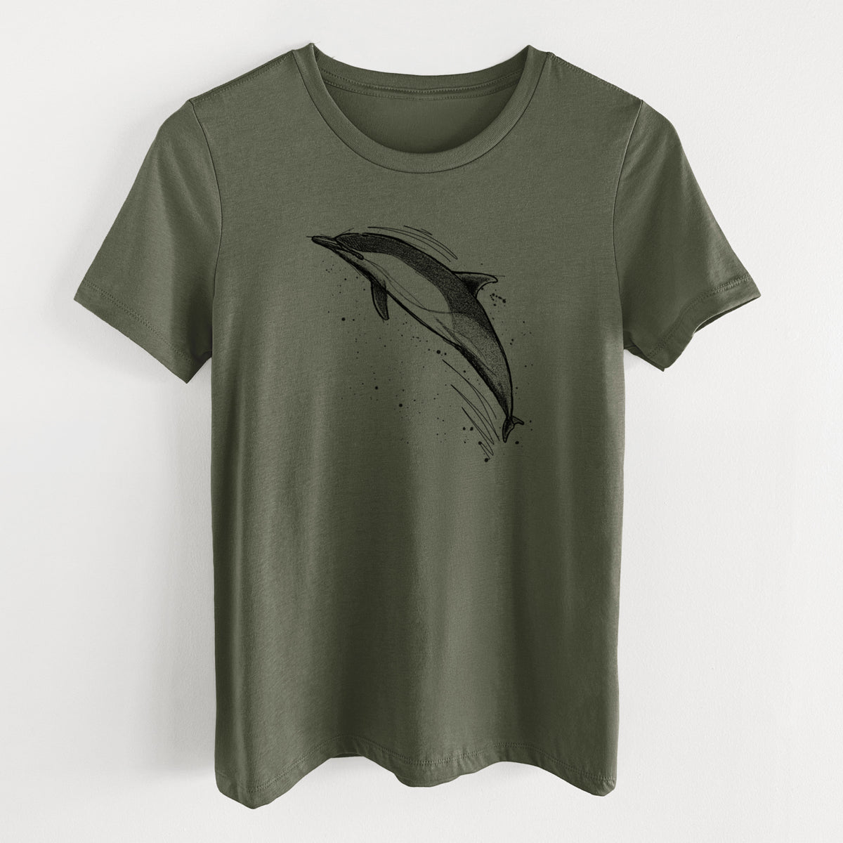 Military green women's relaxed fit cotton t-shirt laid flat, printed with a black ink illustration of a common dolphin leaping, with ink splatters.