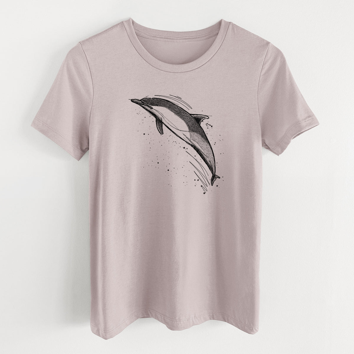 Pink gravel women's relaxed fit cotton t-shirt laid flat, printed with a black ink illustration of a common dolphin leaping, with ink splatters.