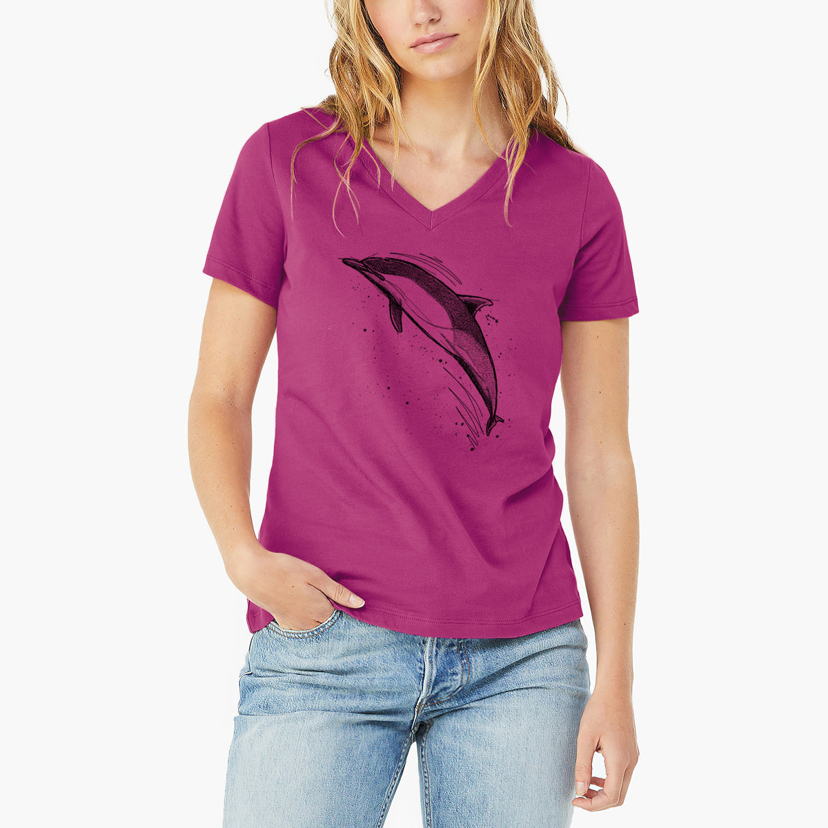 Woman wearing a berry pink women's relaxed fit cotton V-neck t-shirt printed with a black ink illustration of a common dolphin leaping, with ink splatters.
