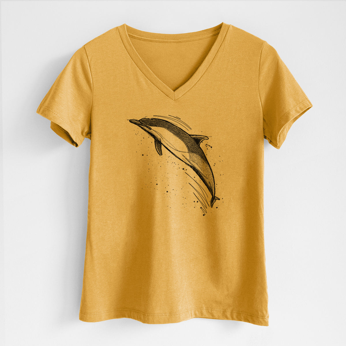 Honeycomb yellow women's relaxed fit cotton V-neck t-shirt laid flat, printed with a black ink illustration of a common dolphin leaping, with ink splatters.