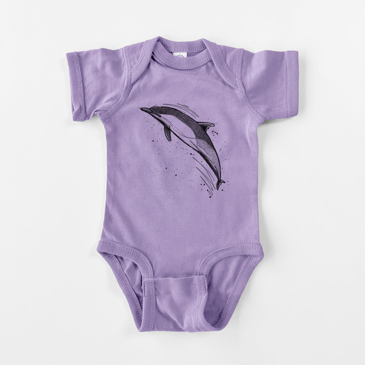 Lavender baby bodysuit laid flat, printed with a black ink illustration of a common dolphin leaping, with ink splatters.