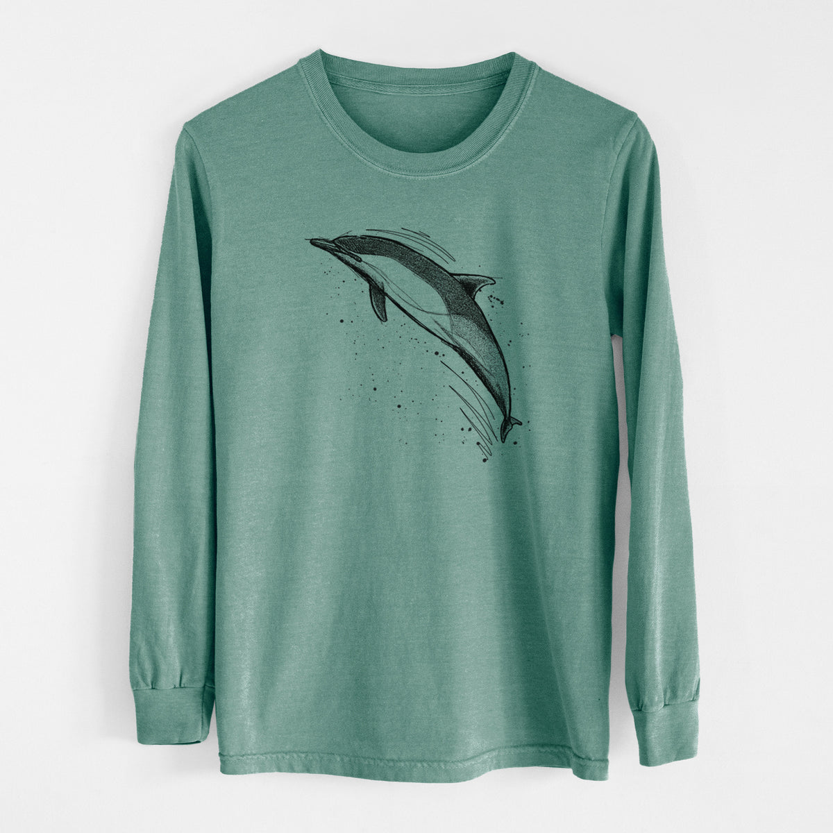 Pine green Comfort Colors long sleeve shirt laid flat, printed with a black ink illustration of a common dolphin leaping, with ink splatters.