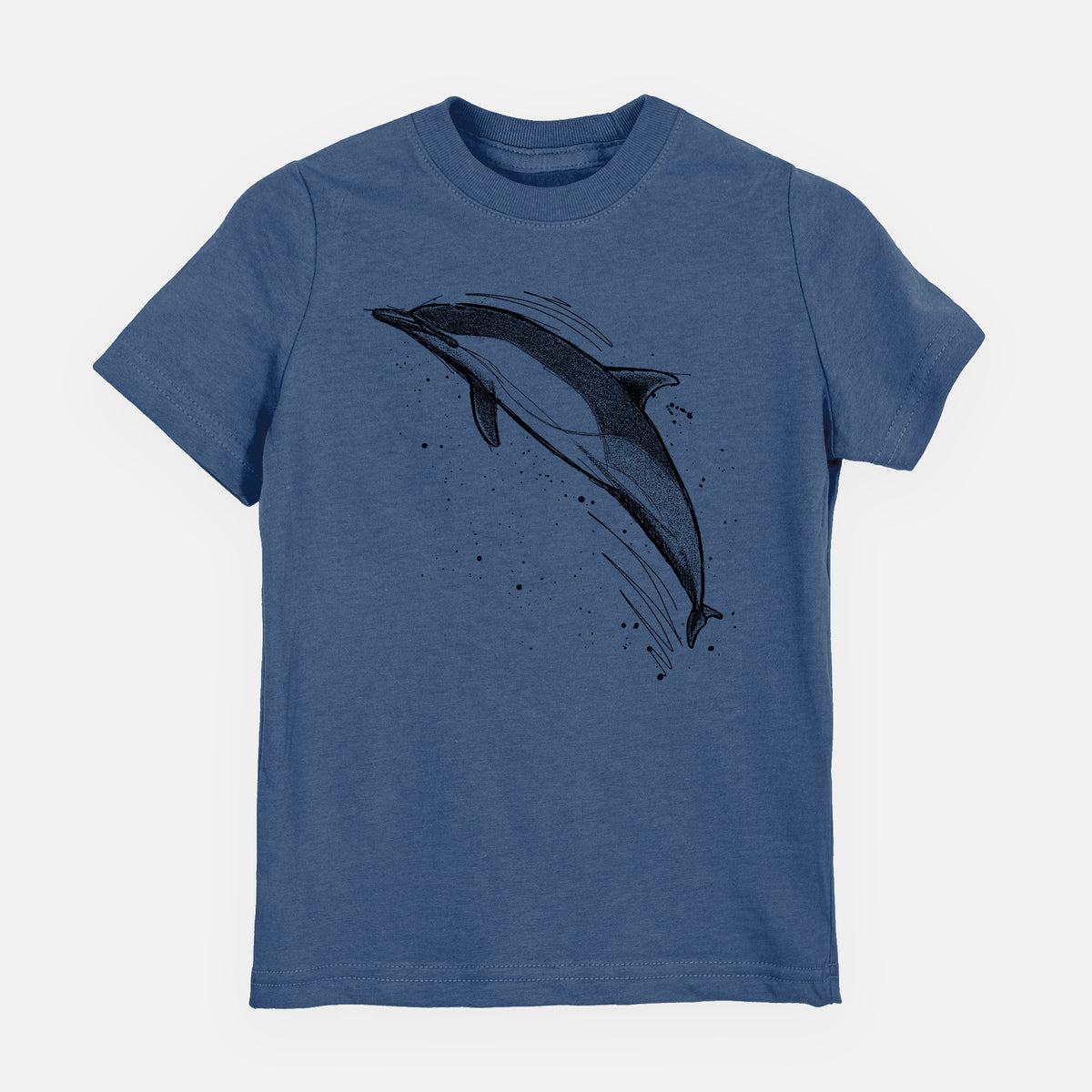 Indigo blue youth t-shirt laid flat, printed with a black ink illustration of a common dolphin leaping, with ink splatters.