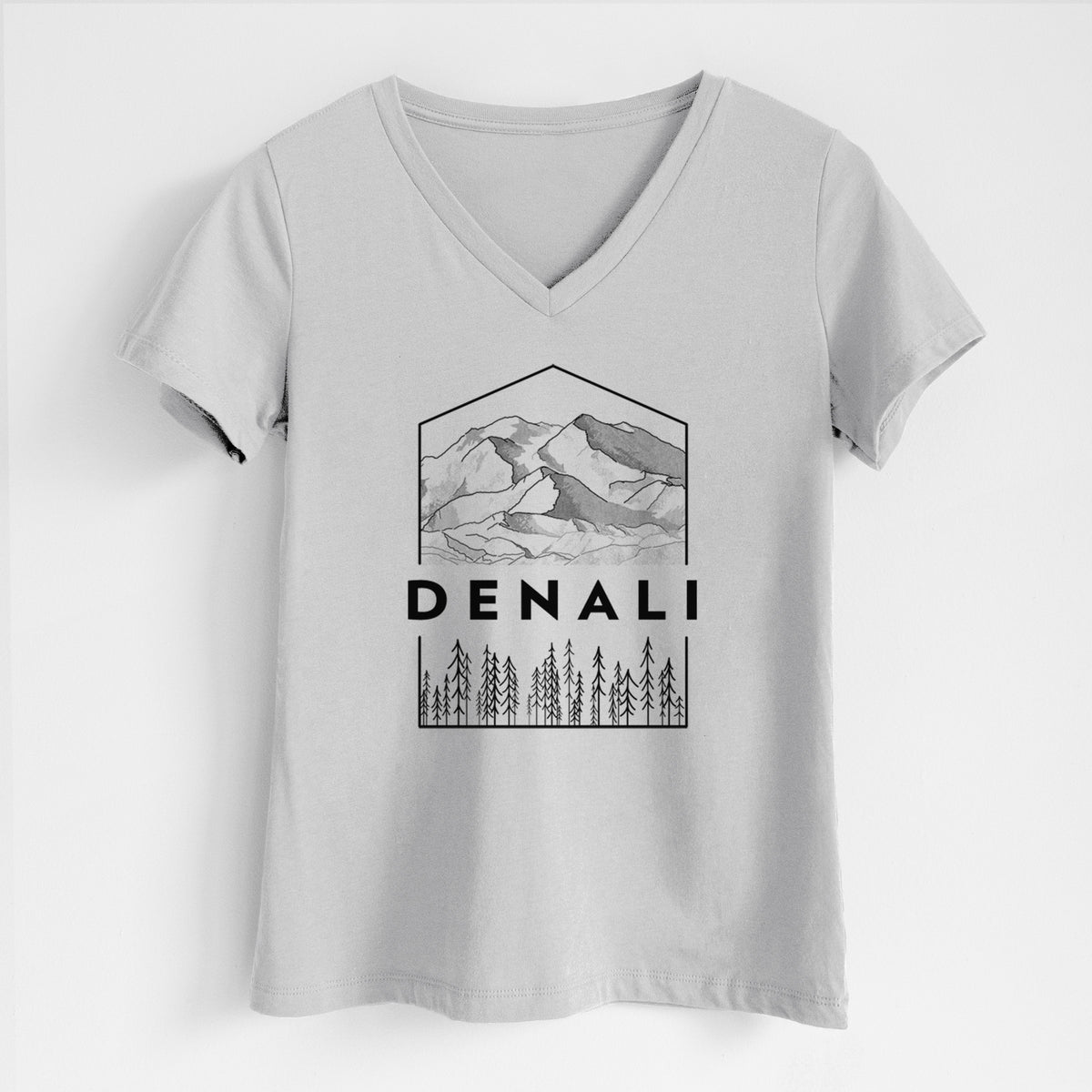 Lunar grey women's relaxed fit cotton V-neck t-shirt laid flat, printed with a black line art badge of the Denali mountain range above pine trees, with the word Denali.