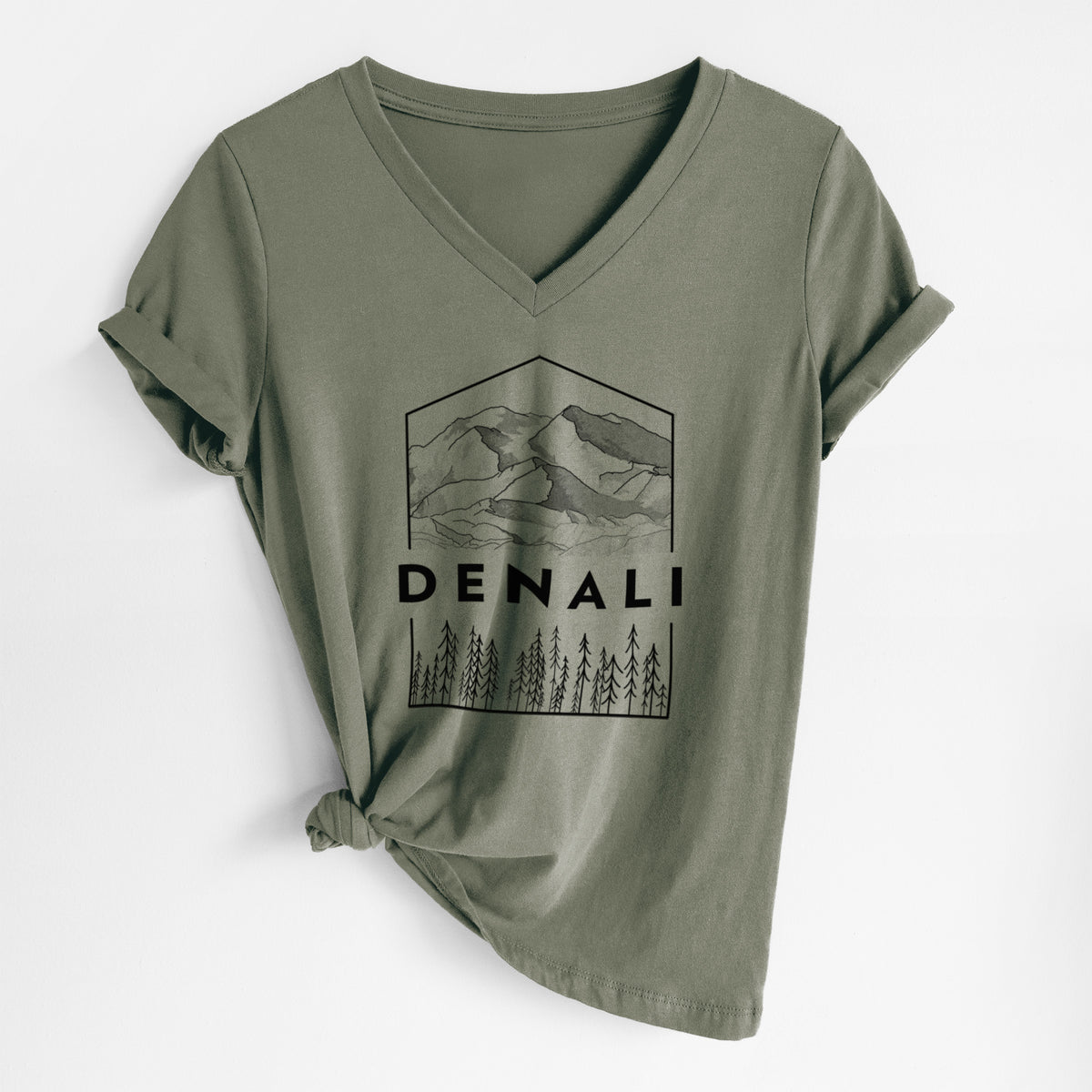 Military green women's relaxed fit cotton V-neck t-shirt laid flat, printed with a black line art badge of the Denali mountain range above pine trees, with the word Denali.