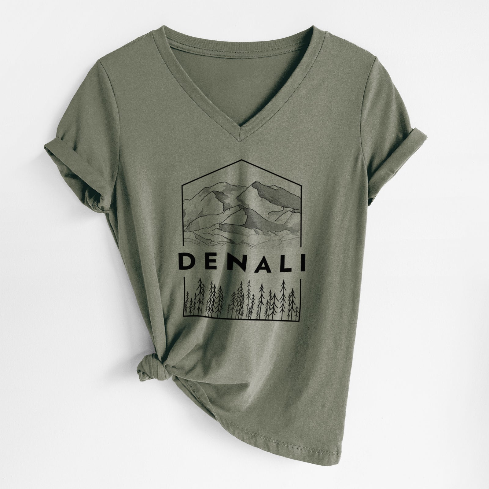 Military green women's relaxed fit cotton V-neck t-shirt laid flat, printed with a black line art badge of the Denali mountain range above pine trees, with the word Denali.