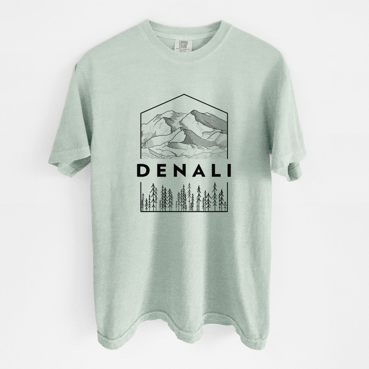 Bay green Comfort Colors t-shirt laid flat, printed with a black line art badge of the Denali mountain range above pine trees, with the word Denali.
