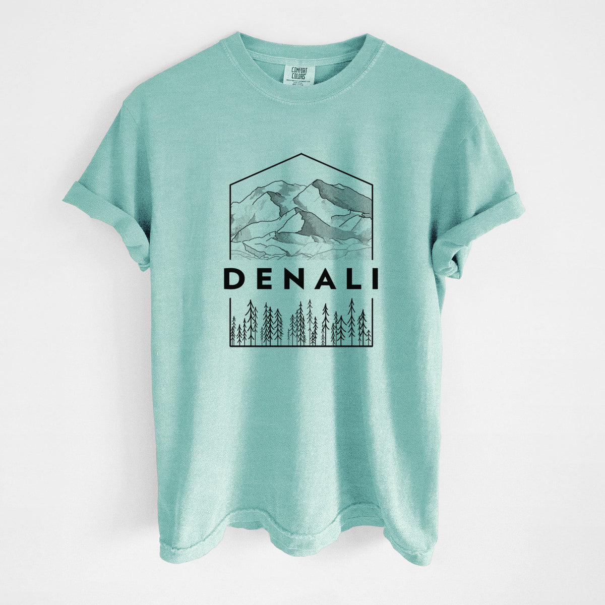 Chalky mint Comfort Colors t-shirt laid flat, printed with a black line art badge of the Denali mountain range above pine trees, with the word Denali.