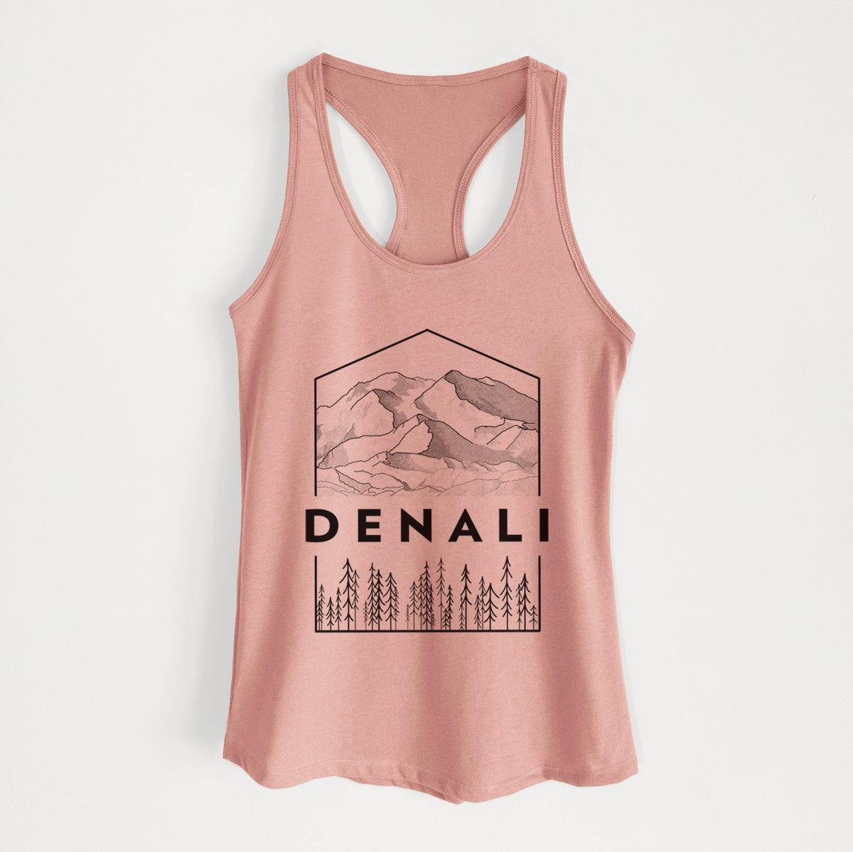 Desert pink women's racerback tank top laid flat, printed with a black line art badge of the Denali mountain range above pine trees, with the word Denali.