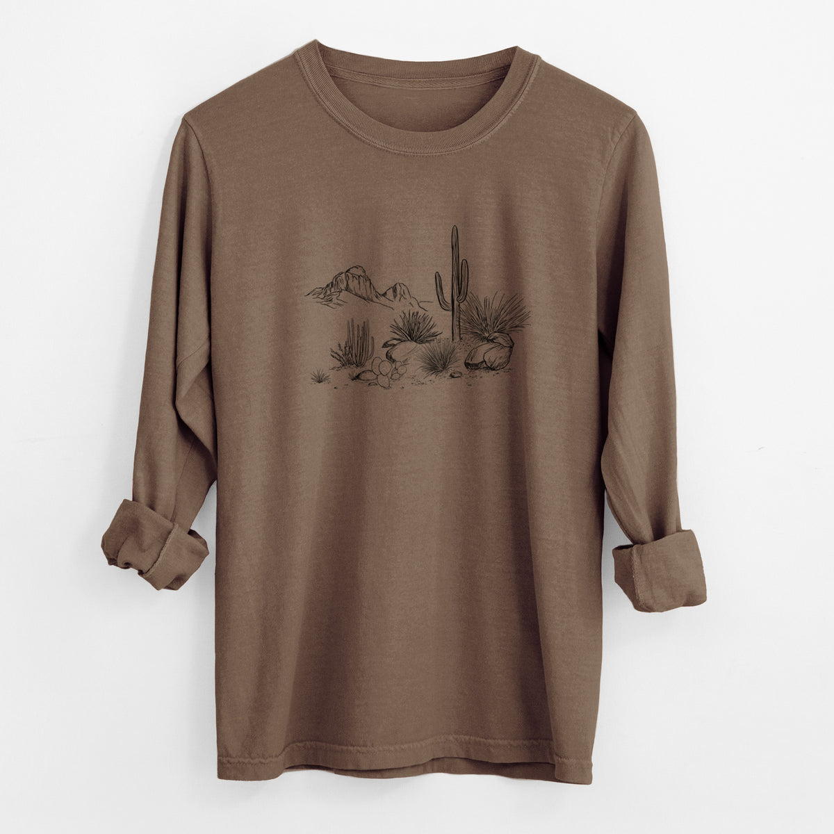 Espresso brown Comfort Colors long sleeve shirt laid flat with the cuffs rolled, printed with a black ink desert scene with a saguaro cactus, agave, rocks and distant mountains.