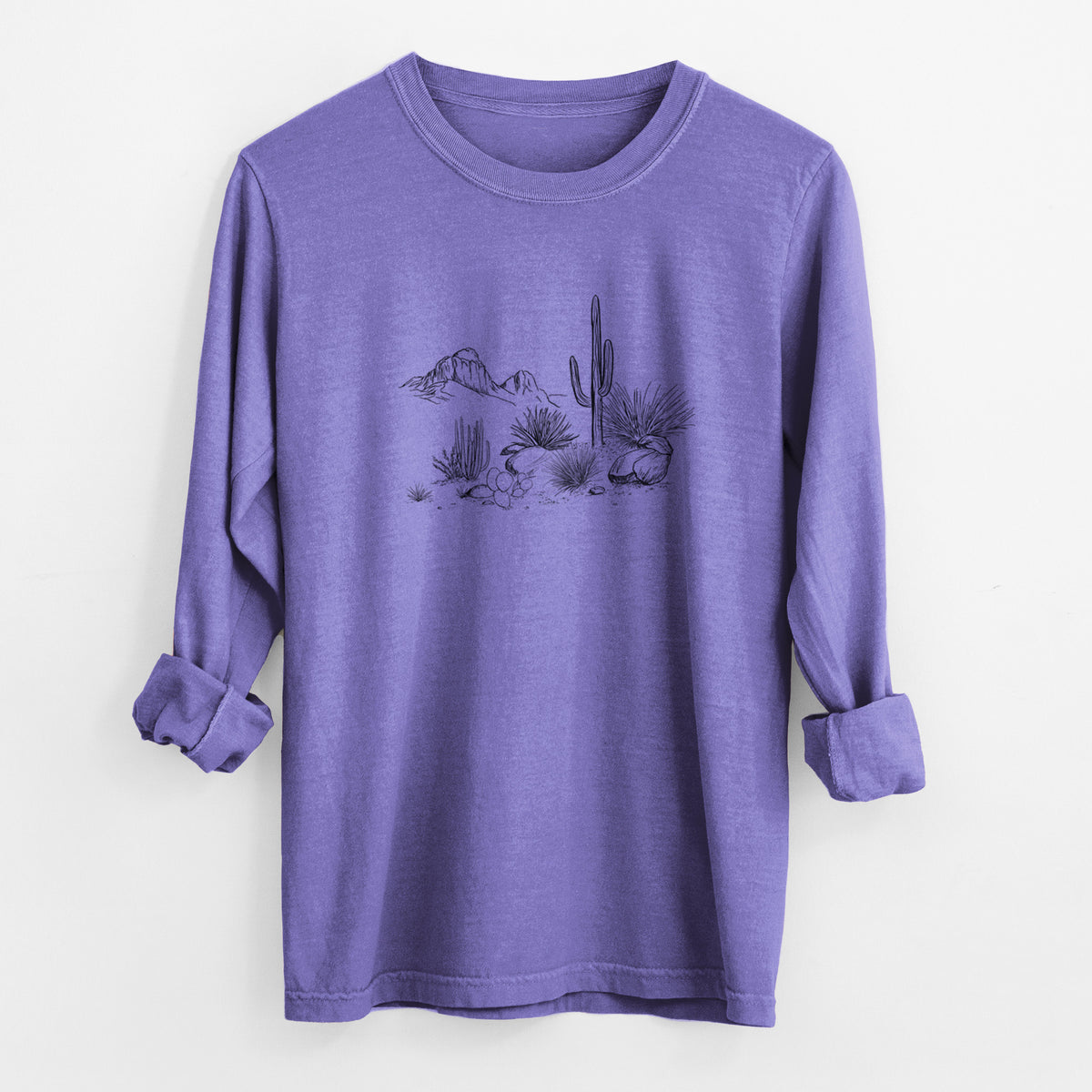 Violet purple Comfort Colors long sleeve shirt laid flat with the cuffs rolled, printed with a black ink desert scene with a saguaro cactus, agave, rocks and distant mountains.
