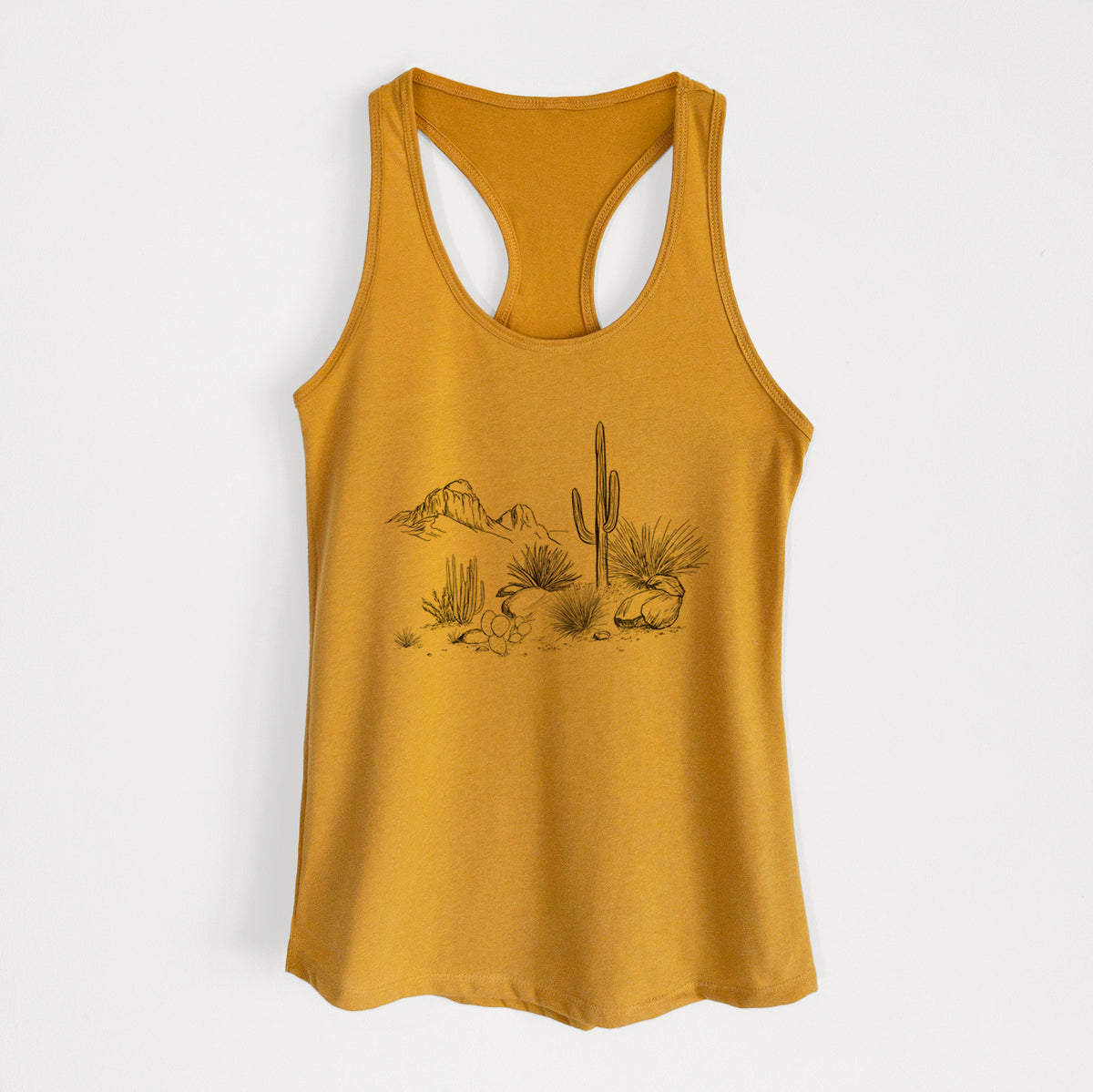 Gold women's racerback tank top laid flat, printed with a black ink desert scene with a saguaro cactus, agave, rocks and distant mountains.