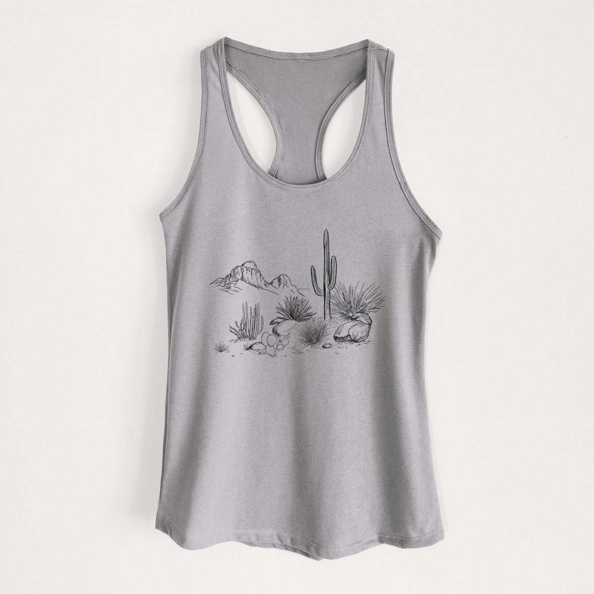 Heather grey women's racerback tank top laid flat, printed with a black ink desert scene with a saguaro cactus, agave, rocks and distant mountains.