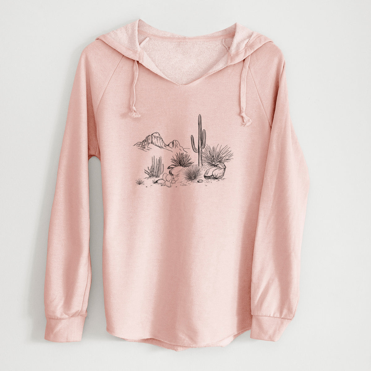 Blush pink women's Cali Wave hooded sweatshirt laid flat, printed with a black ink desert scene with a saguaro cactus, agave, rocks and distant mountains.