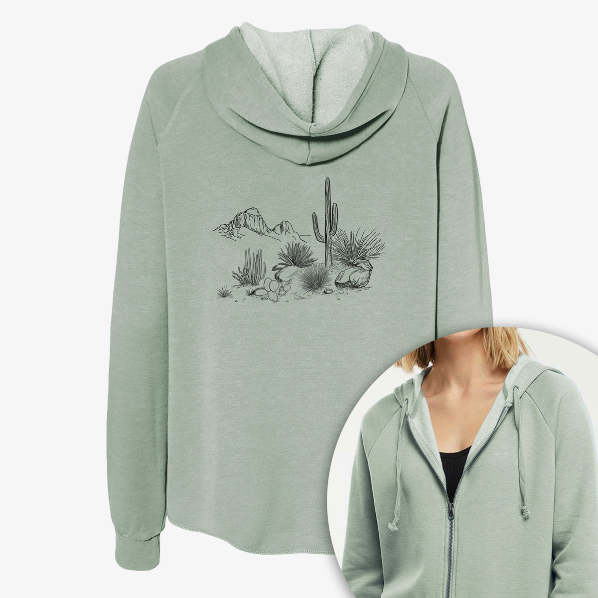Women's Cali Wave zip-up sweatshirt printed with a black ink desert scene with a saguaro cactus, agave, rocks and distant mountains, with a close-up of the zipper.
