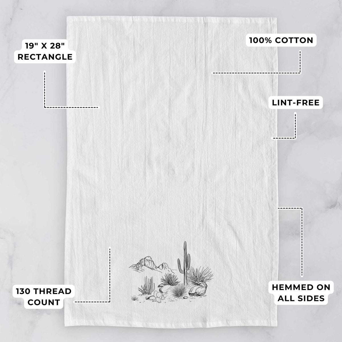 White tea towel printed with a black ink desert scene with a saguaro cactus, agave, rocks and distant mountains, with feature labels: 19 by 28 inch rectangle, 100% cotton, lint-free, 130 thread count, hemmed on all sides.