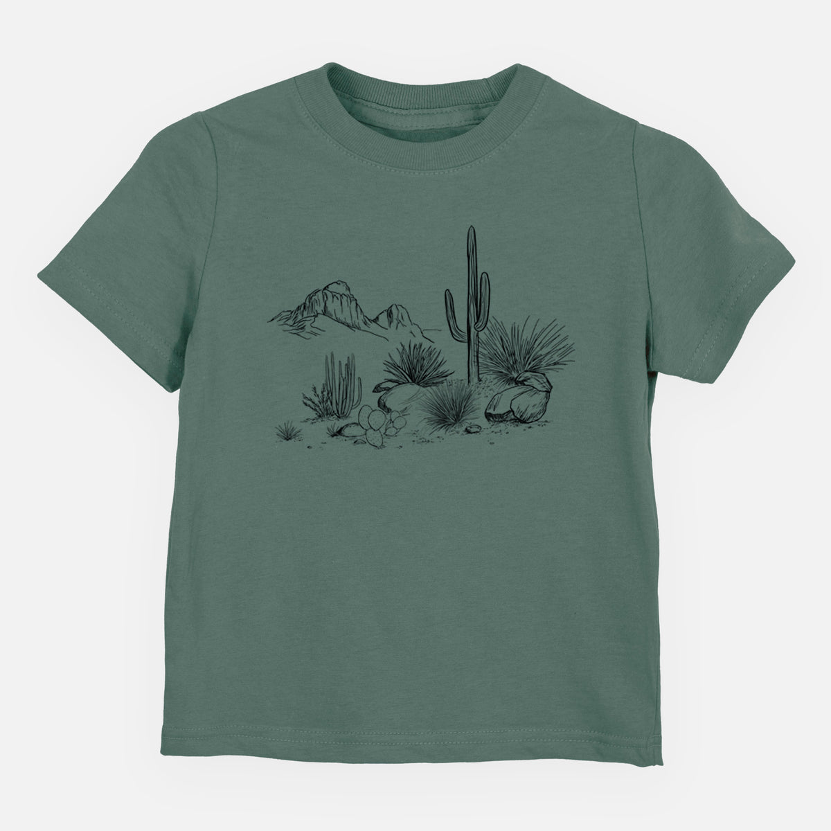 Basil green toddler t-shirt laid flat, printed with a black ink desert scene with a saguaro cactus, agave, rocks and distant mountains.