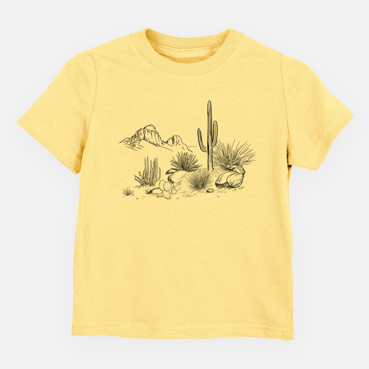 Butter yellow toddler t-shirt laid flat, printed with a black ink desert scene with a saguaro cactus, agave, rocks and distant mountains.