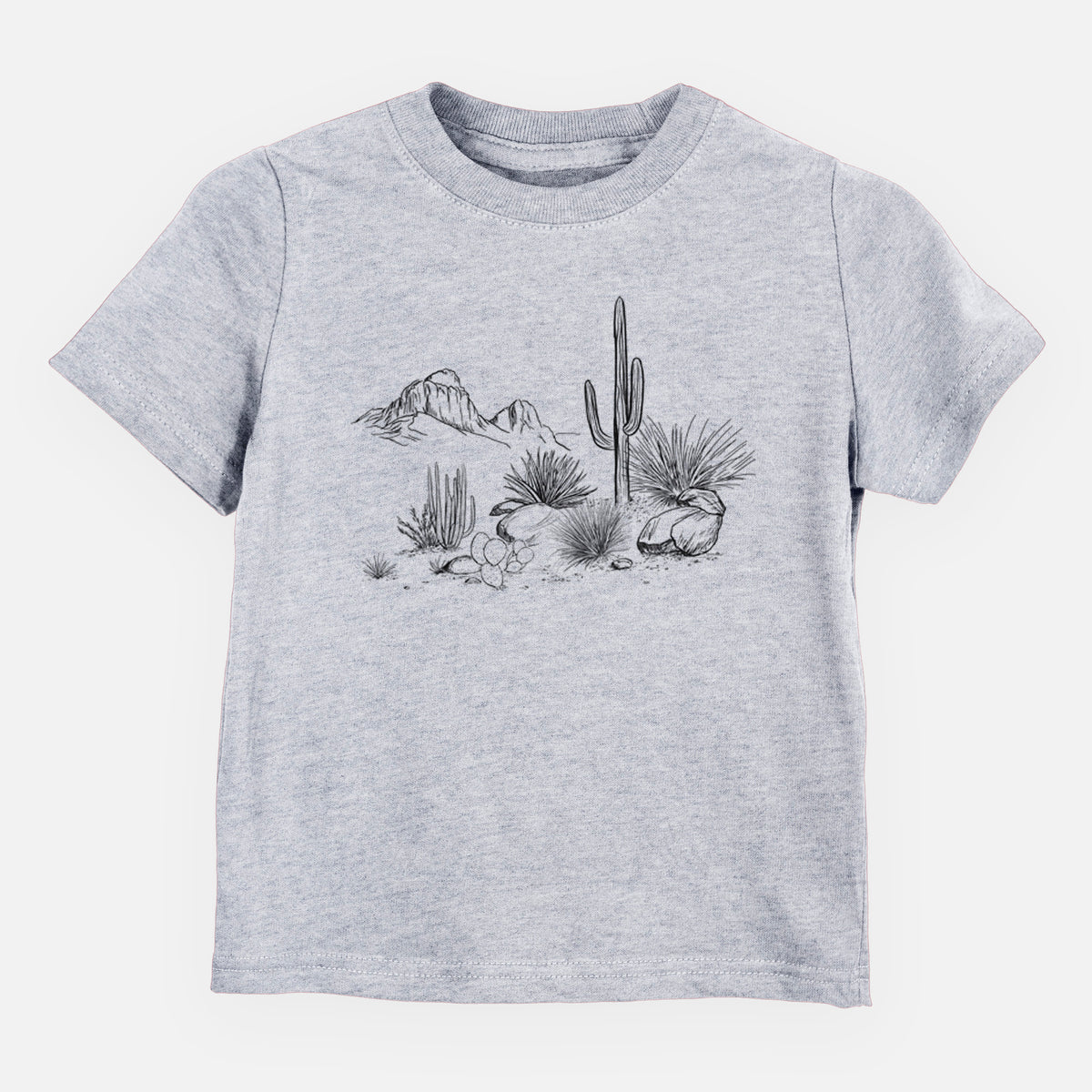 Heather grey toddler t-shirt laid flat, printed with a black ink desert scene with a saguaro cactus, agave, rocks and distant mountains.