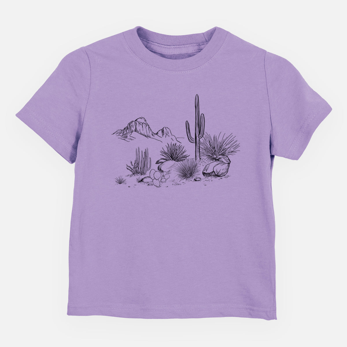 Lavender toddler t-shirt laid flat, printed with a black ink desert scene with a saguaro cactus, agave, rocks and distant mountains.